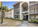 Exterior view of a condo building featuring a walkway and stairs to units at 8215 Sun Spring Cir # 32, Orlando, FL 32825