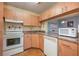Efficient kitchen layout with modern appliances, light wood cabinets, and a convenient pass-through at 8215 Sun Spring Cir # 32, Orlando, FL 32825