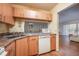 Kitchen featuring light wood cabinets, granite countertops, and a pass-through to the living area at 8215 Sun Spring Cir # 32, Orlando, FL 32825