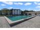 Community pool featuring lounge chairs, pool building and lush vegetation at 8215 Sun Spring Cir # 32, Orlando, FL 32825