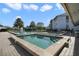 Community pool and hot tub featuring brick pavers, lounge chairs, and building at 8215 Sun Spring Cir # 32, Orlando, FL 32825