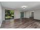 Bright living room with modern flooring and sliding glass doors leading to the backyard at 902 Oleander St, New Smyrna Beach, FL 32168