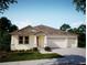 Charming single-story home with neutral stucco, a three-car garage and well manicured lawn at 914 Boyte St, Port Orange, FL 32127