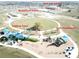 Community park featuring a jogging track, basketball court, playground, and a new K-6 school under construction at 954 Laurel View Way, Groveland, FL 34736