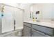 This bathroom features modern vanity and stone countertop, glass enclosed shower, and contemporary fixtures at 954 Laurel View Way, Groveland, FL 34736