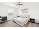 Bedroom featuring neutral decor, a plush bed, and an adjacent study area at 954 Laurel View Way, Groveland, FL 34736