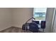 Bright bedroom featuring neutral carpet, a large window, and space perfect for a desk and computer setup at 954 Laurel View Way, Groveland, FL 34736