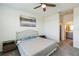 Comfortable bedroom boasts neutral tones, a plush bed, and an ensuite bathroom at 954 Laurel View Way, Groveland, FL 34736