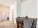 Cozy dining area featuring a wooden table and chairs with gray upholstery adjacent to front entry at 954 Laurel View Way, Groveland, FL 34736