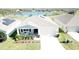 Inviting single-story home with solar panels, a two-car garage, and a cozy front porch, near a scenic lake at 954 Laurel View Way, Groveland, FL 34736