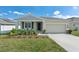 Charming single-story home featuring a well-maintained lawn and two-car garage at 954 Laurel View Way, Groveland, FL 34736