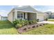 Landscaped front yard with green bushes and a view of the lake nearby at 954 Laurel View Way, Groveland, FL 34736