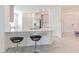 Open kitchen layout with bar seating overlooking the dining and entry areas at 954 Laurel View Way, Groveland, FL 34736