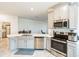 Modern kitchen with stainless steel appliances and a view into the living room at 954 Laurel View Way, Groveland, FL 34736