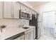 Modern kitchen with stainless steel appliances, quartz countertops, and shaker style cabinets at 954 Laurel View Way, Groveland, FL 34736
