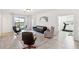 Open-concept living room with tile floors and large windows offering natural light at 954 Laurel View Way, Groveland, FL 34736