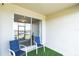 Relaxing covered patio area with stylish blue chairs and views of the lake at 954 Laurel View Way, Groveland, FL 34736