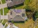 Aerial view of a home with solar panels, patio, and a well maintained backyard at 9816 Palmetto Dunes Ct, Orlando, FL 32832
