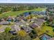 Aerial view of the neighborhood shows the golf course, pond and mature trees at 9816 Palmetto Dunes Ct, Orlando, FL 32832