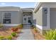 Up-close front door with a decorative wreath and tidy landscaping at 9816 Palmetto Dunes Ct, Orlando, FL 32832