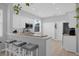 Modern kitchen featuring a breakfast bar with seating, white cabinetry, and stainless steel appliances at 9816 Palmetto Dunes Ct, Orlando, FL 32832