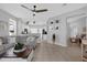 Bright, open-concept living room with tile floors, leading into the kitchen and dining areas at 9816 Palmetto Dunes Ct, Orlando, FL 32832