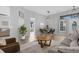 Spacious living area with a cozy seating arrangement, adjacent dining area, and stylish decor at 9816 Palmetto Dunes Ct, Orlando, FL 32832