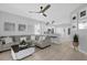 Bright living room featuring a comfortable sectional sofa, ceiling fan, and stylish decor at 9816 Palmetto Dunes Ct, Orlando, FL 32832