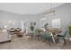 Open-concept living and dining areas with tile flooring, modern furniture, and abundant natural light at 9816 Palmetto Dunes Ct, Orlando, FL 32832