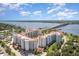 Beautiful aerial view of a condo complex near a bridge with waterfront views, lush landscaping and sunny skies at 1 John Anderson Dr # 317, Ormond Beach, FL 32176