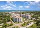 Expansive aerial view of waterfront condo complex with ocean views, lush landscaping, and bright, sunny skies at 1 John Anderson Dr # 317, Ormond Beach, FL 32176