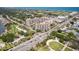 Wide aerial view of condo complex near roadways, showcasing lush landscaping, nearby parks, and a beautiful neighborhood at 1 John Anderson Dr # 317, Ormond Beach, FL 32176