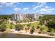 Gorgeous aerial view of waterfront condo with a playground, lush greenery, and bright sunny skies for activities at 1 John Anderson Dr # 317, Ormond Beach, FL 32176