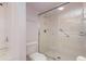 Bathroom with updated shower, toilet, and white tile; accessible features present at 1 John Anderson Dr # 317, Ormond Beach, FL 32176