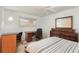 Bedroom with ceiling fan, window, neutral walls and carpet, with a writing desk at 1 John Anderson Dr # 317, Ormond Beach, FL 32176