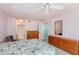 An airy bedroom featuring light pink walls, carpet floors, and ceiling fan with a full-size bed at 1 John Anderson Dr # 317, Ormond Beach, FL 32176