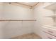 A simple walk-in closet with multiple height clothing rods and built in shelving and drawers at 1 John Anderson Dr # 317, Ormond Beach, FL 32176