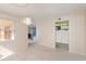 Dining area with a decorative light fixture and view to living spaces through wide doorway at 1 John Anderson Dr # 317, Ormond Beach, FL 32176