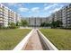 Exterior view of building with tropical landscaping and community walkway at 1 John Anderson Dr # 317, Ormond Beach, FL 32176