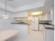 Well-lit kitchen with classic white appliances and cabinets offers a clean and timeless look at 1 John Anderson Dr # 317, Ormond Beach, FL 32176