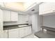 Practical kitchen features white appliances, plenty of cabinets, and a convenient breakfast bar at 1 John Anderson Dr # 317, Ormond Beach, FL 32176
