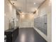 Hallway featuring tile walls, dark flooring, and rows of mailboxes provides a functional and tidy space at 101 S Eola Dr # 1119, Orlando, FL 32801