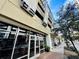View from street of building, showing commercial spaces, walkways, and inviting restaurant entrance at 101 S Eola Dr # 1208, Orlando, FL 32801
