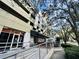 Exterior showcases the building's integration of parking facilities with retail access and streetscape design at 101 S Eola Dr # 1208, Orlando, FL 32801