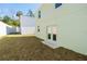A well-kept backyard featuring a grassy area, a privacy fence, and the home's back facade at 1039 Morningside Dr, Eustis, FL 32726