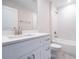 Modern bathroom with a white vanity, quartz countertop, and white hexagon tiled shower and bath at 1039 Morningside Dr, Eustis, FL 32726