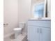 Clean bathroom with a modern white vanity, quartz countertop and tiled floor at 1039 Morningside Dr, Eustis, FL 32726