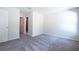 A comfortable bedroom features soft gray carpet and natural light at 1039 Morningside Dr, Eustis, FL 32726