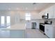 Bright kitchen featuring white cabinets, stainless steel appliances, and a central island at 1039 Morningside Dr, Eustis, FL 32726