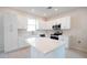 Bright kitchen featuring white cabinets, stainless steel appliances, and a central island at 1039 Morningside Dr, Eustis, FL 32726